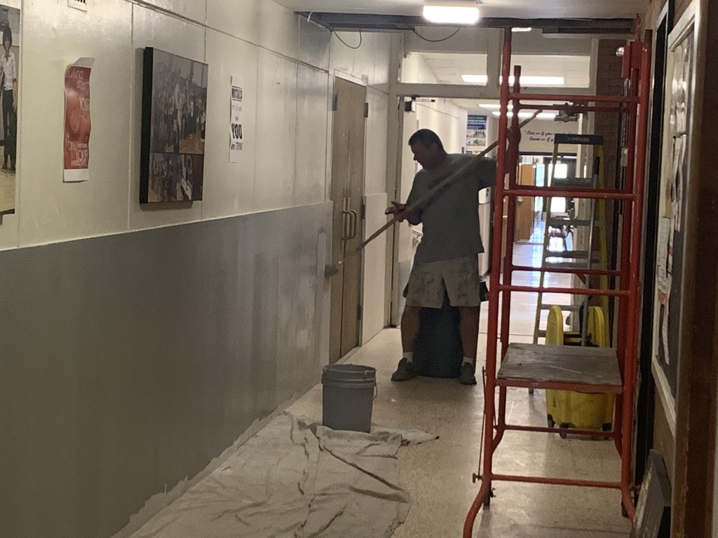 Mr. French is applying the first coat of paint on the new drywall